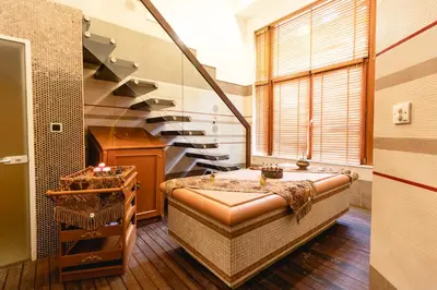 a bathroom with a bath tub and a staircase at Emerald Beach Resort & Spa in Ravda