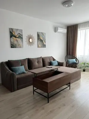 a living room with a couch and a coffee table at New and stylish apartment Tuthon in Pomorie