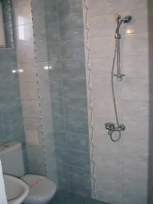 a bathroom with a shower with a toilet and a sink at Sianie Guest House in Ravda