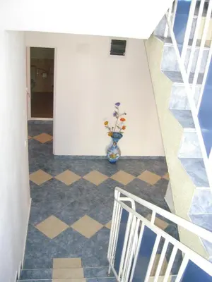 a staircase with a vase of flowers in a room at Sianie Guest House in Ravda