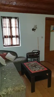 a living room with a couch and a table at Вила Мила in Tsarevo