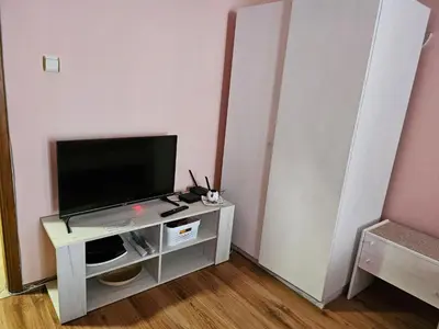 a living room with a television on a table at Стая за гости на Бургас 1 in Burgas City