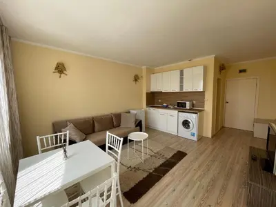 a living room with a couch and a table at Charming 1 bedroom apartment in Sunny Beach in Sunny Beach