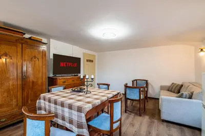 a living room with a table and chairs and a couch at Seagull Apartment in Varna City