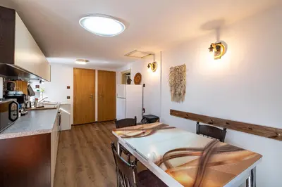 a kitchen and dining room with a counter and a table at Seagull Apartment in Varna City
