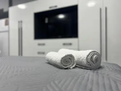 a couple of towels sitting on top of a bed at NJ bedroom in Varna City