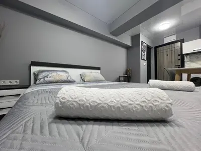 a bedroom with a large bed with a white comforter at NJ bedroom in Varna City
