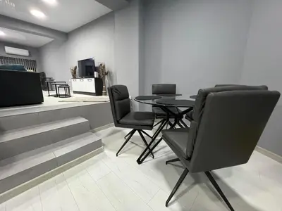 a dining room with a table and chairs at NJ Luxury Room in Varna City