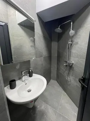 a bathroom with a sink and a shower at NJ Luxury Room in Varna City