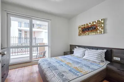 a bedroom with a bed and a large window at Private 1-BD Apartment with Balcony in Sveti Vlas by Flat Mаnаger in Sveti Vlas