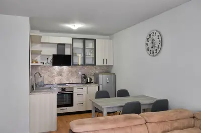 a kitchen and dining room with a table and a couch at Private 1-BD Apartment with Balcony in Sveti Vlas by Flat Mаnаger in Sveti Vlas