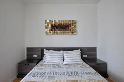 a bedroom with a bed with two pillows at Private 1-BD Apartment with Balcony in Sveti Vlas by Flat Mаnаger in Sveti Vlas