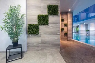 a lobby with a wall with plants on it at Burgas Residence 504 l Indoor Parking l Breakfast & SPA available in Burgas City