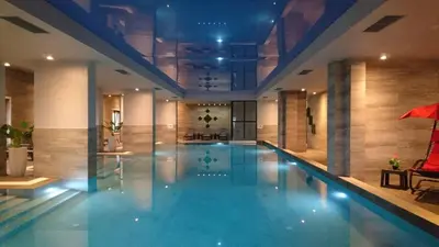 a large swimming pool in a building at Burgas Residence 504 l Indoor Parking l Breakfast & SPA available in Burgas City