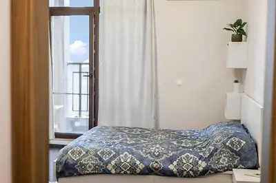 a bedroom with a bed and a window at Burgas Residence 504 l Indoor Parking l Breakfast & SPA available in Burgas City