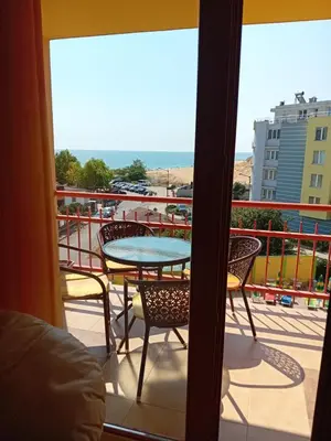 a patio with a table and chairs on a balcony at Златна Дюна - до южния плаж на Несебър in Nesebar