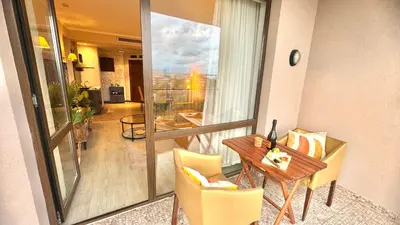 a room with a table and chairs and a balcony at Luxury sea view, 5star Barcelo on Beach in Sunny Beach