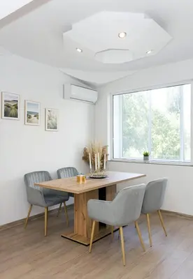 a dining room with a wooden table and chairs at Bright 2-Bedroom Apartment Near Varna City Center by Flat Mаnаger in Varna City