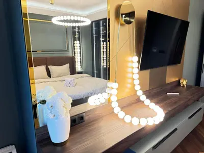 a room with a bedroom with a bed and a mirror at Kandinski Lux Apart in Burgas City