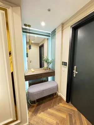 a bathroom with a vanity with a bench and a mirror at Kandinski Lux Apart in Burgas City