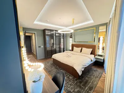 a bedroom with a bed and a table in it at Kandinski Lux Apart in Burgas City
