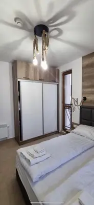 a bedroom with a bed and a ceiling fan at Luxury Apartments in Cascadas Family Resort Sunny Beach in Sunny Beach