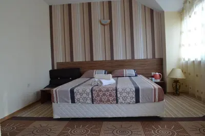 a bedroom with a bed with two pillows at Stella Del Mare Guest House in Kiten