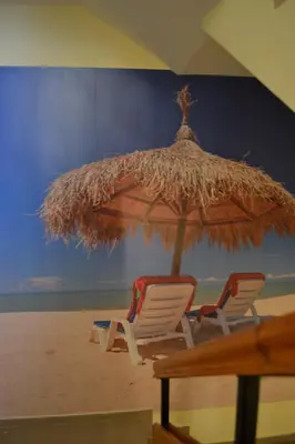 two chairs and an umbrella on the beach at Stella Del Mare Guest House in Kiten