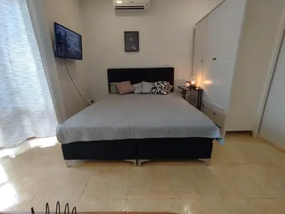 a bedroom with a large bed in a room at Garden of Eden - Sea View studio in Sveti Vlas