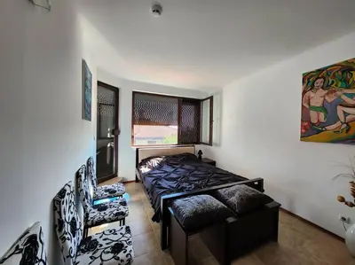 a bedroom with a bed and a couch in it at Bay view villas sunny beach entire villa in Kosharitsa
