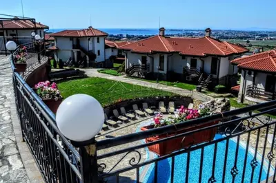 a balcony of a house with a swimming pool at Bay view villas sunny beach entire villa in Kosharitsa