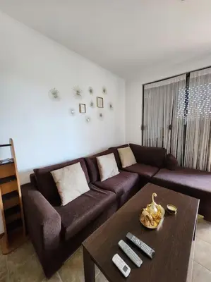 a living room with a brown couch and a coffee table at Bay view villas sunny beach entire villa in Kosharitsa