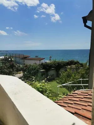 a view of the ocean from the balcony of a house at Вилла Яна in Sveti Vlas