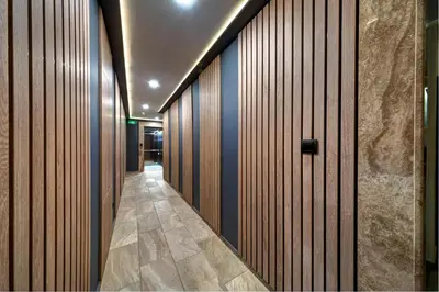 a hallway with wood paneled walls and a door at Paloma - in the center of the city in Sunny Beach