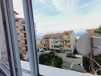 a window with a view of a street and buildings at Guest Apartment Rusalka in Sveti Vlas