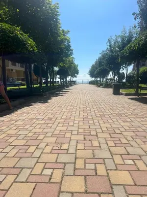 a brick road with trees in a park at Midia Grand Resort Aheloy in Aheloy