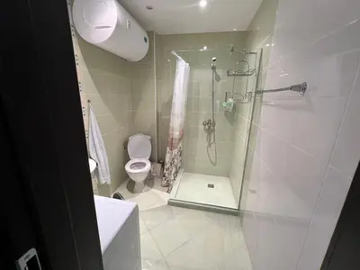 a bathroom with a shower and a toilet at Midia Grand Resort Aheloy in Aheloy