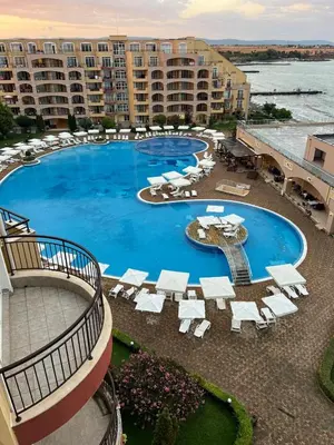 a large swimming pool with lounge chairs and a resort at Midia Grand Resort Aheloy in Aheloy
