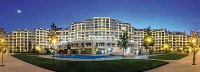 a large building with a courtyard in front of it at АТ apartment - Pool View in Varna City