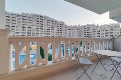 a balcony with a view of a large building at АТ apartment - Pool View in Varna City