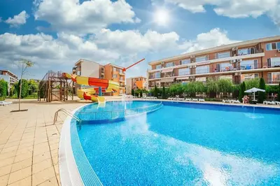 a swimming pool with a slide in front of a building at Sunny beach family apartment 302, Sluneční pobřeží in Sunny Beach