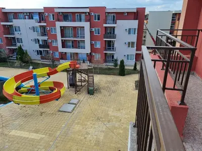 a playground in front of a building with a slide at Sunny beach family apartment 302, Sluneční pobřeží in Sunny Beach