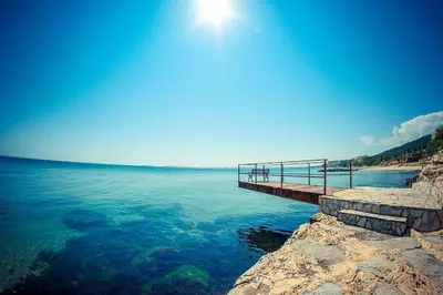 a pier on the shore of a body of water at Roof top sea view apartment 167,2ložnice,4-7 osob in Sveti Vlas