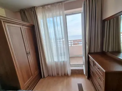 a room with a large window and a dresser with a balcony at Roof top sea view apartment 167,2ložnice,4-7 osob in Sveti Vlas