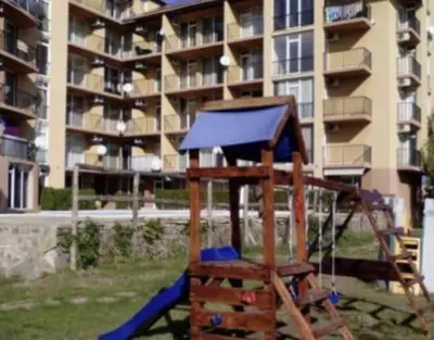 a playground in front of a large apartment building at Sunny view South studio Мир Авангарда in Sunny Beach