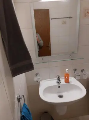 a bathroom with a white sink and a mirror at Просторная квартира в популярном комплексе in Sunny Beach