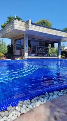 a swimming pool in front of a house at Luxury Apartment in Cascadas Family Resort Sunny Beach in Sunny Beach