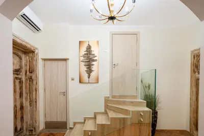 a staircase in a house with a chandelier at Elite place Suite in Varna City