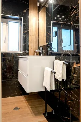 a bathroom with a white sink and a mirror at Elite place Suite in Varna City