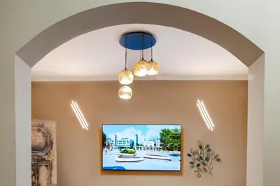 a hallway with an archway and a painting on the wall at Elite place Suite in Varna City
